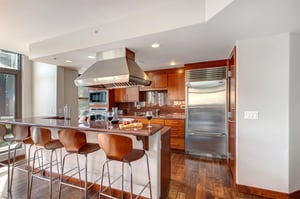 Lowell 402s first kitchen with cherry wood cabinets and hardwood floors and granite countertops