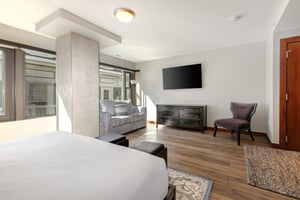 Lowell 402 offers another bedroom with a king size bed, couch, and flat screen TV..