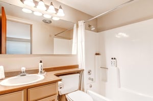 The en suite bathroom offers a bathtub and shower combination.