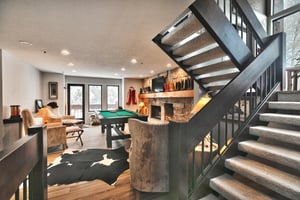 A second living room with a , sitting area, pool table and flat screen TV.
