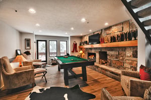 A second living room with a , sitting area, pool table and flat screen TV.