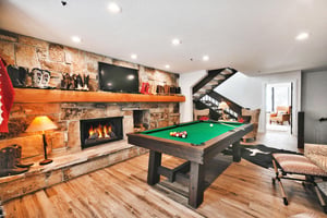 A second living room with a , sitting area, pool table and flat screen TV.