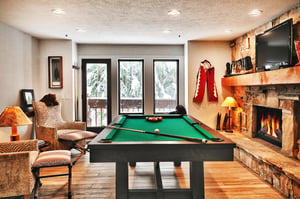 A second living room with a , sitting area, pool table and flat screen TV.