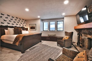 A spacious bedroom with a king size bed and sitting area.