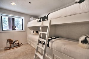 A bedroom with two sets of twin size bunk beds.