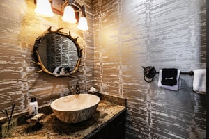 A powder room with antler mirror.