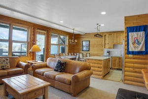 Open concept living room with cozy leather couches.