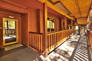 The covered entrance to Comstock 203 with log cabin exterior.