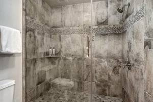 The main suite offers a tiled walkin shower.