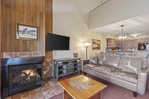 Snow Flower 127s living room with cozy couches and gas burning fireplace.