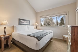 The main suite with a kingsize bed and large picture window.