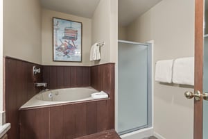 The en suite bathroom with a deep soaker tub and walkin shower.