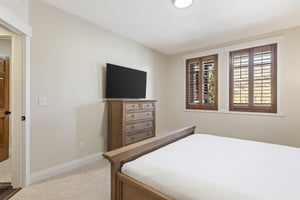 The main suite with a kingsize bed and flat screen TV.