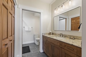 The en suite bathroom with a separate water closet and single sink vanity.