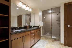 Ensuite main bathroom with glass panel shower door and double vanity sinks
