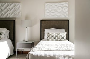 Beautiful natural light streaming in from the window wall on the twin bed in the final guest bedroom