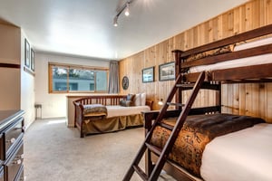 The loft has a twin day bed and a bunk bed with a queen bed on the bottom and twin bed on the top.