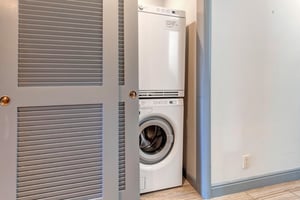 A private stackable washer and dryer.