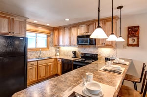 Snow Flower 20 offers a wellequipped kitchen with black appliances and breakfast bar with seating for 3.
