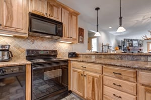 Snow Flower 20 offers a wellequipped kitchen with black appliances and a breakfast bar.
