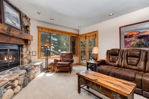 Snow Flower 20 offers a cozy living room with gas burning fireplace with stone surround and leather furnishings.