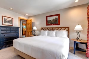 Snow Flower 20s main suite has a kingsize bed and wooden furnishings.