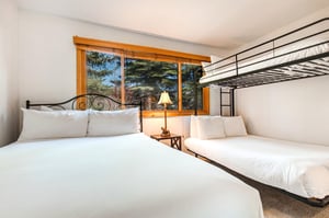 The second bedroom has a queen size bed and a bunk bed with a full on the bottom and a twin on the top.