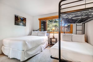 The second bedroom has a queen size bed and a bunk bed with a full on the bottom and a twin on the top.