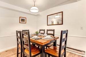 The dining area has a dining table and seating for 6 guests.