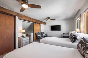 The loft with a twin size day bed, two twin size beds, and a sitting area.