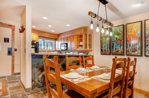 The dining table offers seating for 6 and crisp white dinnerware.
