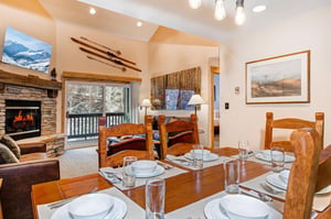 The dining table offers seating for 6 and crisp white dinnerware.