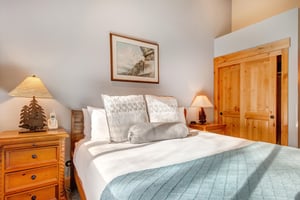 The main suite has a kingsize bed and wooden furniture.