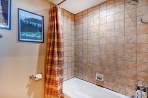 The upstairs bathroom has a bathtub and shower combination.