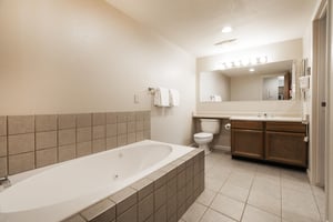Ensuite main bathroom invites you to relax in the jetted tub after a day on the slopes
