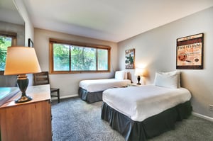 The second bedroom features two comfortable twinsized beds and an abundance of natural lights through the picture window