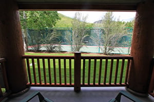 The private patio includes views of the tennis courts