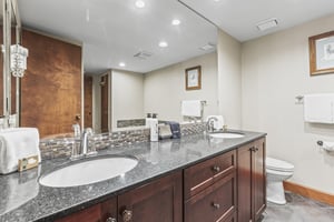 The main bedrooms en suite bathroom with double sink vanity.