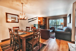 Dining area includes a rectangular table with seating for 6