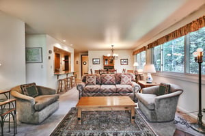 Southwest style couch sofa sleeper, two swivel barrel accent chairs in the living room, window wall overlooking aspen groves