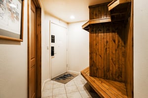 Entryway with wooden bench and racks
