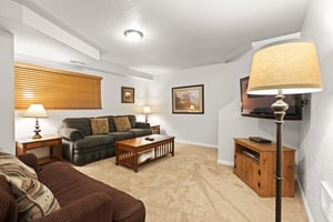 The third living area with comfortable seating, wood furniture, and flat screen TV.
