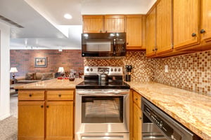 Park Station 124 has a well equipped kitchen with granite countertops and wood cabinets.