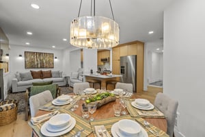 Snow Flower 44s dining area with wooden round table and seating for 6 guests.