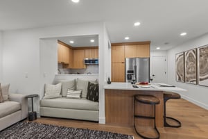 The open concept dining and living area with a breakfast bar with seating for 2.