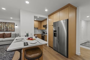 The kitchen with modern wood cabinetry and stainless steel appliances.