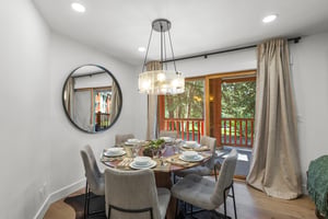 Snow Flower 44s dining area with wooden round table and seating for 6 guests.
