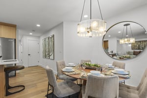 Snow Flower 44s dining area with wooden round table and seating for 6 guests.