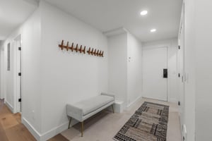The entryway offers a comfortable bench and place to hang coats.