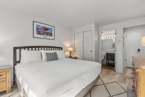 The main suite offers a king size bed and crisp white bedding.